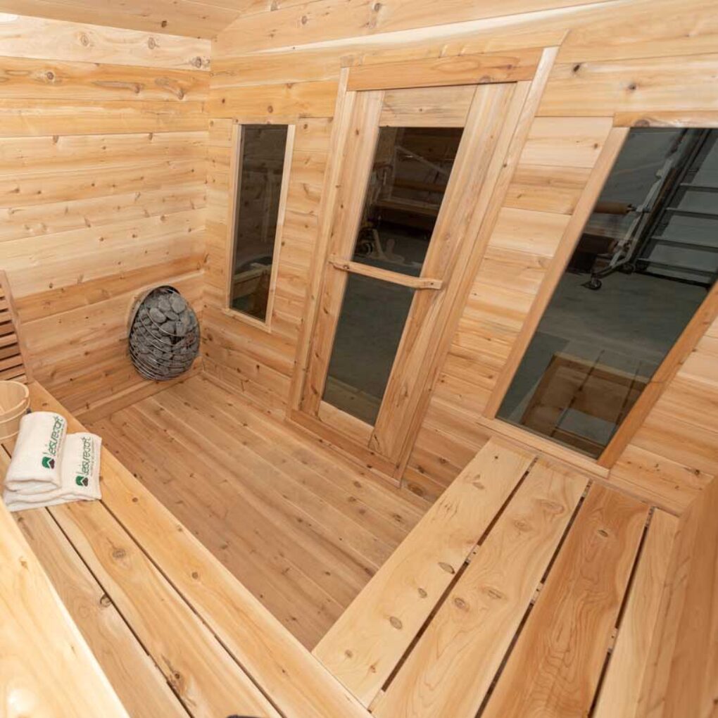 Front interior view of a Georgian cabin sauna with benches and a charming porch.