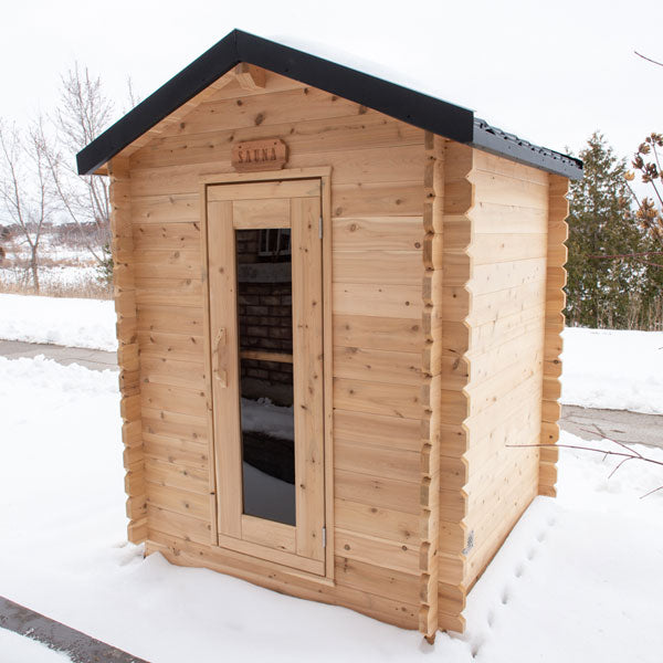 Front door view of the Granby Cabin Sauna with a snowy background.