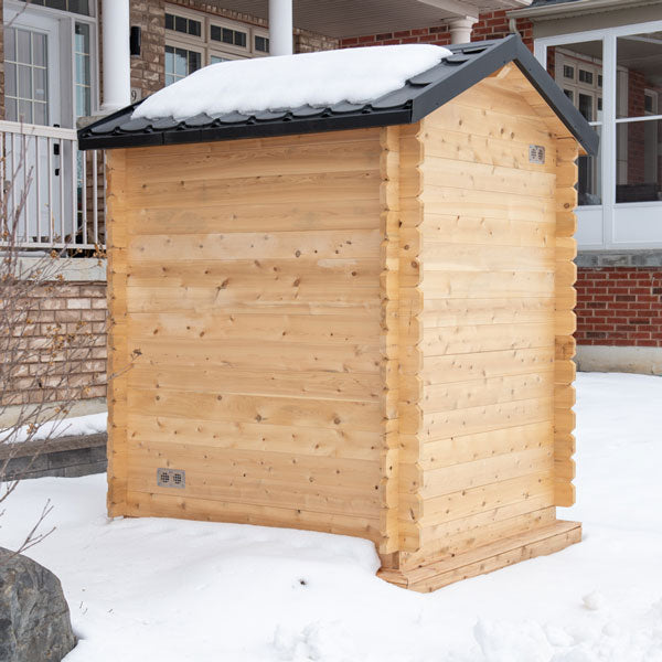 Back and right side view of the Granby Cabin Sauna, with a snowy background.
