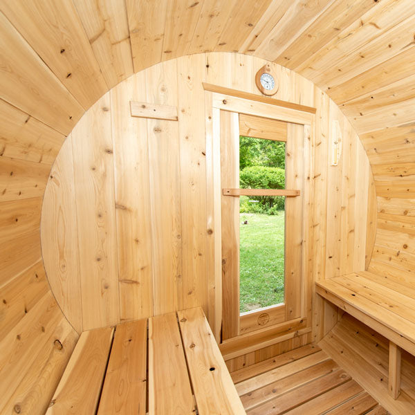 Inside view from the front door of a Harmony Barrel Sauna, showcasing the benches.