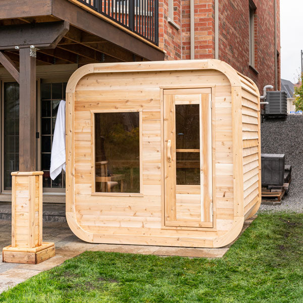 Front view of a Canadian Timber Luna Sauna featuring a glass window and door.