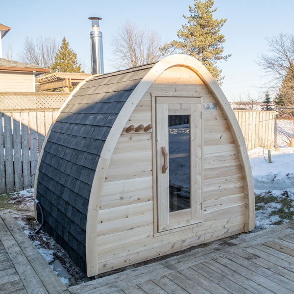 Front and side roof view of a Mini POD Sauna with a fence in the background.