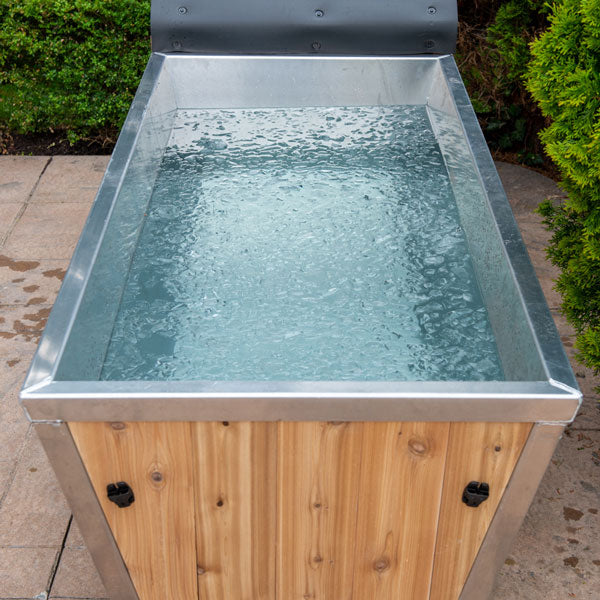 Different angle view of the Polar Plunge Tub, showcasing the open design with ice cubes on the water's surface.