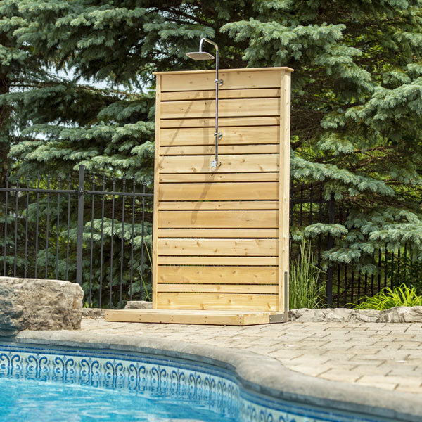 Front view of the Savannah Outdoor Shower positioned near the poolside, highlighting its stylish design and outdoor setting.