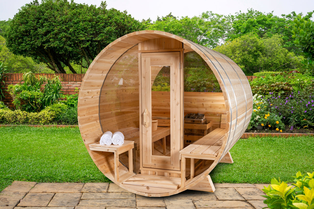 Front view of the Serenity MP Barrel Sauna featuring a porch, glass door, and windows.