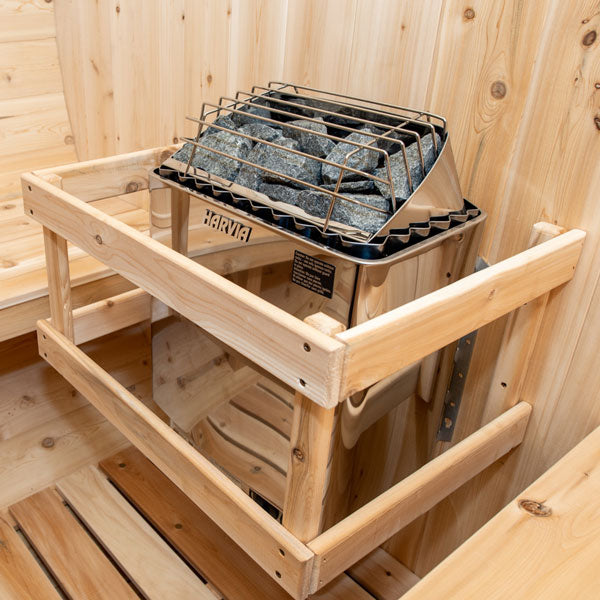Inside view of a tranquility barrel sauna, featuring a sauna heater.