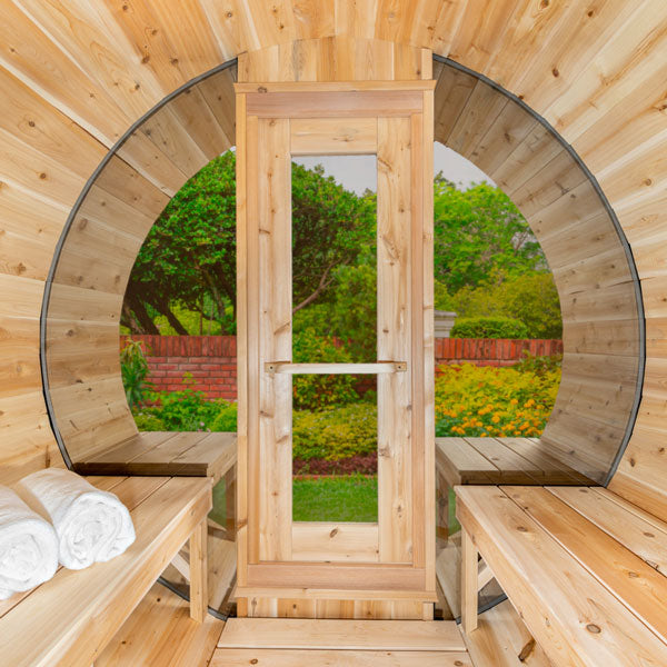 Inside front view of the Tranquility MP Barrel Sauna, featuring a glass door and two benches.