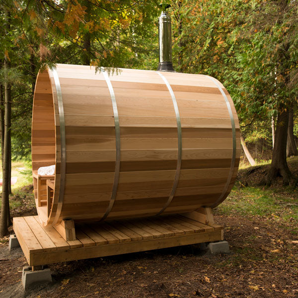 A wide view of a top chimney and heat shield set with an attached water tank, situated outdoors. The setup is prominently displayed against a clear sky, showcasing its design and functionality in a distant perspective.