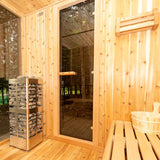 Front and right side view of the Homecraft Revive 9kW electric sauna heater positioned inside a cabin sauna.