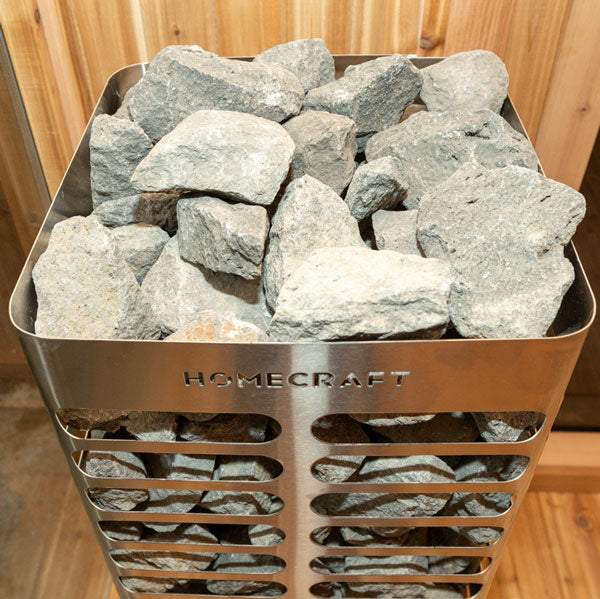 A close-up view of the Revive sauna heater rocks, featuring a variety of sizes and textures. Designed for use in a sauna, arranged around the heating element for optimal heat retention and distribution.