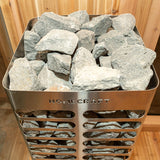 A close-up view of the Revive sauna heater rocks, featuring a variety of sizes and textures. Designed for use in a sauna, arranged around the heating element for optimal heat retention and distribution.
