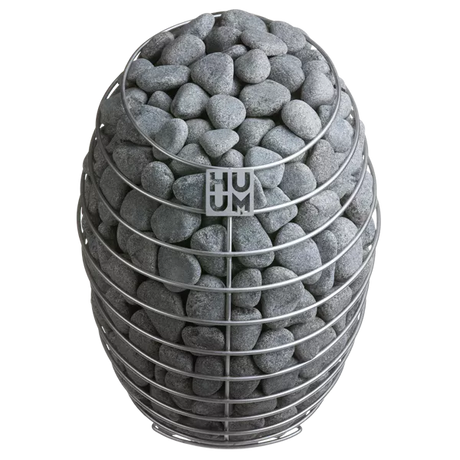 HUUM Drop electric sauna heater featuring a stainless steel finish, complemented by sauna rocks.