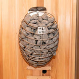 HUUM Drop 9KW electric sauna heater mounted on a wooden wall, showcasing its stainless steel finish and sauna stones.