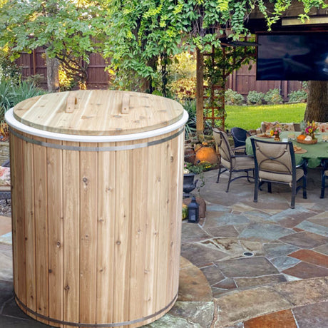 Baltic Cold Plunge Tub positioned next to an outdoor dining table by Pathio, creating an inviting and relaxing outdoor space.