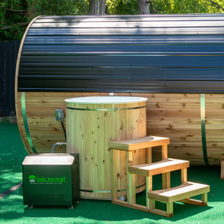 Baltic Cold Plunge Tub with side stairs and integrated chiller, accompanied by a barrel sauna in the background, creating a serene relaxation area.