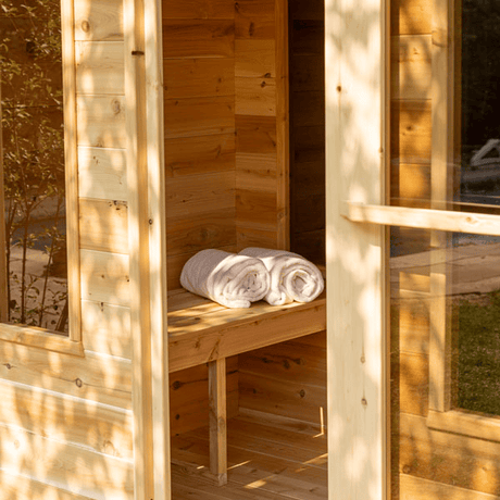 View of the Georgian Cabin Sauna with Changing Room featuring an open door and bench
