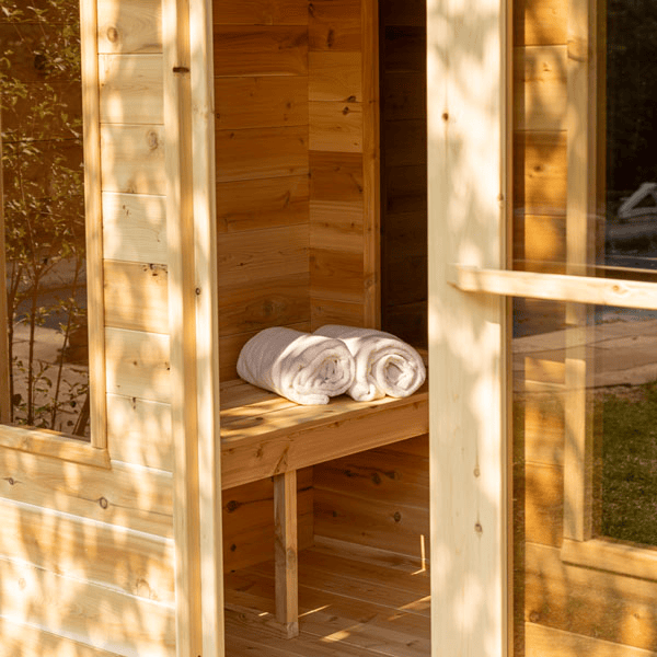 View of the Georgian Cabin Sauna with Changing Room featuring an open door and bench