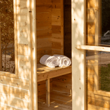 View of the Georgian Cabin Sauna with Changing Room featuring an open door and bench
