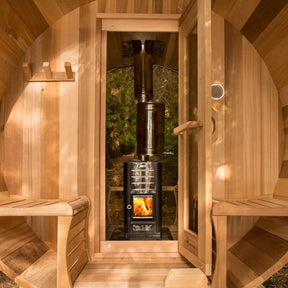 An exterior view of the Top Chimney and Heat Shield Set equipped with a water tank, specifically designed for full back wall saunas. The image captures the entire assembly installed on a sauna, emphasizing its design and functionality in a natural outdoor setting.