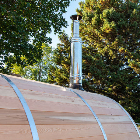 A close-up view of the top chimney and heat shield set featuring an integrated water tank, showcasing the details and design elements.